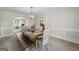 Dining room featuring wood table, bench seating and decorative lighting fixture at 3842 Monticello St, Douglasville, GA 30135