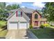 Charming two-story home with a two car garage, brick facade, and well-maintained lawn at 3842 Monticello St, Douglasville, GA 30135