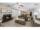 Cozy living room with a fireplace, ceiling fan and views into the dining area and kitchen at 3842 Monticello St, Douglasville, GA 30135