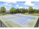Two well-maintained community tennis courts with lush green surroundings under a sunny sky at 3842 Monticello St, Douglasville, GA 30135