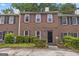 Traditional brick townhome with symmetrical facade, multi-pane windows and manicured greenery at 244 Timber Creek Ln, Marietta, GA 30060