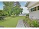 Sprawling backyard with mature trees and water view at 270 E James Cir, Hampton, GA 30228