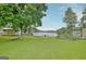 Lush backyard with mature trees and a glimpse of the lake, creating a private oasis at 270 E James Cir, Hampton, GA 30228