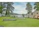 Picturesque backyard with lush grass, mature trees, and a scenic view of the lake at 270 E James Cir, Hampton, GA 30228