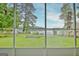 Serene backyard view from the screened-in porch with lush greenery and glimpse of the lake at 270 E James Cir, Hampton, GA 30228