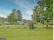 View of home from backyard featuring a lake in the background at 270 E James Cir, Hampton, GA 30228