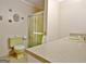 Bathroom featuring a shower stall, yellow toilet, and vanity with a neutral countertop at 270 E James Cir, Hampton, GA 30228