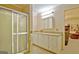 Bathroom with shower, neutral cabinets, and updated lighting fixtures at 270 E James Cir, Hampton, GA 30228