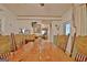 Dining room featuring wood floors, table, chairs, and view into kitchen area at 270 E James Cir, Hampton, GA 30228