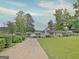 View of home from driveway and a glimpse of the lake behind the property at 270 E James Cir, Hampton, GA 30228