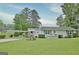Charming single-story home featuring a carport, well-maintained lawn, and inviting front porch at 270 E James Cir, Hampton, GA 30228