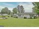 Charming single-story home with carport and a well-manicured front lawn and garden at 270 E James Cir, Hampton, GA 30228