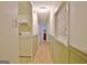 Long hallway with light-colored laminate flooring, storage cabinets, and white walls at 270 E James Cir, Hampton, GA 30228