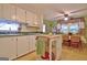 Functional kitchen area with white appliances, island, and a cozy dining nook at 270 E James Cir, Hampton, GA 30228