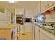 Bright kitchen featuring white cabinets, green countertops, and lots of natural light at 270 E James Cir, Hampton, GA 30228