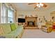 Relaxing living room featuring a brick fireplace and window with decorative curtain at 270 E James Cir, Hampton, GA 30228