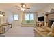 Bright living room with neutral carpet, large window, and comfortable seating at 270 E James Cir, Hampton, GA 30228