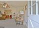 Bright living room featuring neutral carpet, ceiling fan, and a view into another room at 270 E James Cir, Hampton, GA 30228