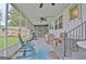 Relaxing screened-in porch with rocking chairs, ceiling fans, and adjacent shed, perfect for enjoying the outdoors at 270 E James Cir, Hampton, GA 30228