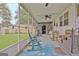 Charming screened-in porch with ceiling fans, rocking chairs, and a glimpse of the backyard shed at 270 E James Cir, Hampton, GA 30228
