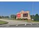 Entrance sign for Atlanta Motor Speedway with Coca-Cola ads and other branding under a clear, blue sky at 270 E James Cir, Hampton, GA 30228