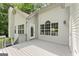 A gray painted wooden deck off the back of the home overlooks the spacious yard at 40 Wenham Ln, Sharpsburg, GA 30277