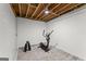Finished basement area with an exercise machine and free weights on a patterned rug at 40 Wenham Ln, Sharpsburg, GA 30277