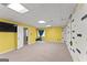 Finished basement features carpet, neutral paint and a colorful brick accent wall at 40 Wenham Ln, Sharpsburg, GA 30277
