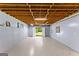 Large, unfinished basement with white double doors leading to the backyard at 40 Wenham Ln, Sharpsburg, GA 30277