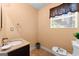Powder room with granite countertop sink, tile flooring, and window for natural light at 40 Wenham Ln, Sharpsburg, GA 30277