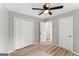 Bright bedroom with a ceiling fan, light gray walls, and wood-look flooring at 40 Wenham Ln, Sharpsburg, GA 30277