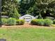 Community entrance sign for Strathmore surrounded by manicured landscaping and greenery at 40 Wenham Ln, Sharpsburg, GA 30277