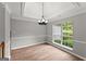 Bright dining area with a tray ceiling and a large window offering a beautiful view at 40 Wenham Ln, Sharpsburg, GA 30277