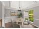 Bright dining area with a tray ceiling, modern chandelier, and view to the backyard at 40 Wenham Ln, Sharpsburg, GA 30277
