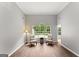 Bright, open living room with large arched window and hardwood floors at 40 Wenham Ln, Sharpsburg, GA 30277