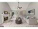 Bright living room features a fireplace, ceiling fan, neutral paint, and a large white couch at 40 Wenham Ln, Sharpsburg, GA 30277
