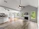 Open living room with a fireplace, hardwood floors, neutral paint and a view into the kitchen at 40 Wenham Ln, Sharpsburg, GA 30277