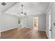 Spacious main bedroom featuring a tray ceiling, ceiling fan, and wood floors, offering a bright and open feel at 40 Wenham Ln, Sharpsburg, GA 30277