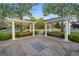 Picturesque community arbor with benches, surrounded by manicured landscaping and brick-paved walkways at 113 Regents Sq, Peachtree City, GA 30269