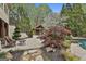 Landscaped backyard with a custom pool, lounge area, and outdoor cabana at 113 Regents Sq, Peachtree City, GA 30269