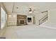 Finished basement showcasing a stone fireplace, built-in cabinets, and a staircase at 113 Regents Sq, Peachtree City, GA 30269