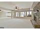 Open basement with a stone fireplace, and large windows providing natural light at 113 Regents Sq, Peachtree City, GA 30269