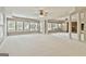 Large basement with many windows offering natural light, stone fireplace, and built-in cabinets at 113 Regents Sq, Peachtree City, GA 30269