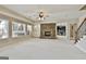Finished basement featuring a stone fireplace, built-in shelving, and a staircase at 113 Regents Sq, Peachtree City, GA 30269