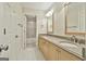 Elegant bathroom featuring double vanities with granite countertops, and a beautifully tiled shower/tub combination at 113 Regents Sq, Peachtree City, GA 30269