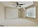 Charming bedroom with a large closet, a window, and a ceiling fan at 113 Regents Sq, Peachtree City, GA 30269
