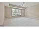 Spacious bedroom with large window, neutral walls, and carpeted floor at 113 Regents Sq, Peachtree City, GA 30269