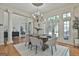 Dining room with views of the entryway, featuring a chandelier and expansive windows at 113 Regents Sq, Peachtree City, GA 30269