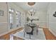 Light-filled dining room featuring French doors, chandelier, and elegant decor at 113 Regents Sq, Peachtree City, GA 30269