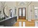 Spacious foyer showcasing hardwood floors, double doors, and elegant console table at 113 Regents Sq, Peachtree City, GA 30269